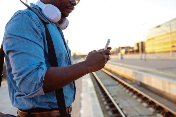 istock Close shot African American man using smart phone on the train station 1623500866