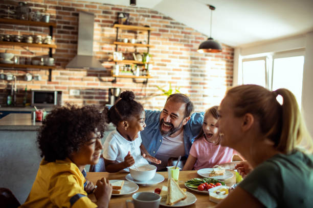 istock Young mixed family having breakfast together at home 1623501387