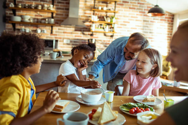 istock Young mixed family having breakfast together at home 1623502509