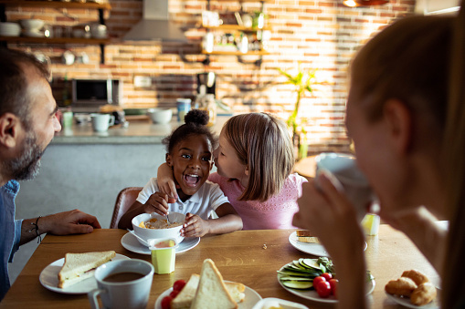 Close up of a Young mixed family having breakfast together at home