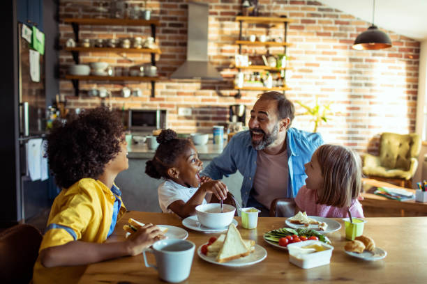 istock Single father having breakfast with his three kids 1623510527