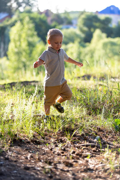 istock A little boy runs through the forest 1623527124