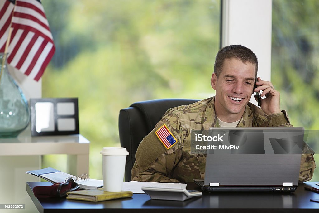 American Soldier in his office Handsome American soldier behind his computer -talking on the phone Veteran Stock Photo