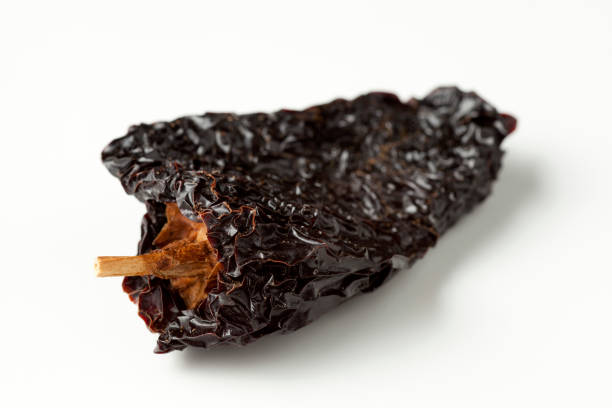 Chile Ancho are dried poblanos chilis and they're popular in Mexican cuisine, here they're photographed on a white background.
