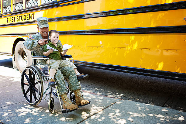 Veteran and boy in wheelchair stock photo
