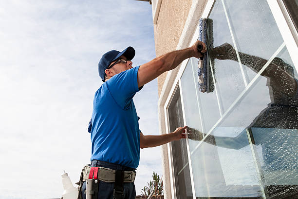 Window Cleaning Man cleaning window of a home. custodian stock pictures, royalty-free photos & images