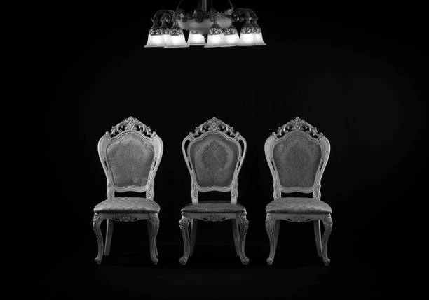 istock three vintage chairs and a chandelier in a black room 1623533150