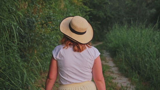 Caucasian Woman Tourist Walking Down Countryside Path near Umbrian Village in Italy