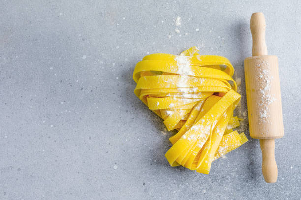 istock Fresh italian pasta with flour on bright background 1623561932