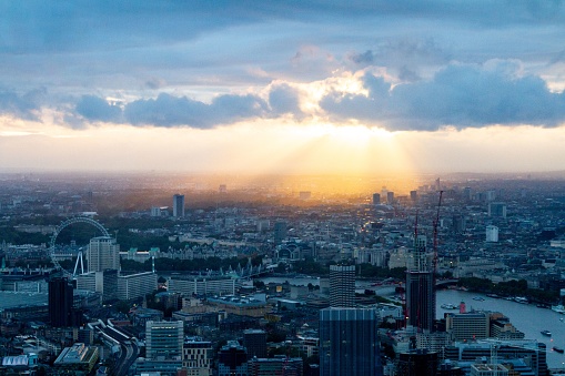 A stunning aerial view of a vibrant sunset over the iconic city of London, England.