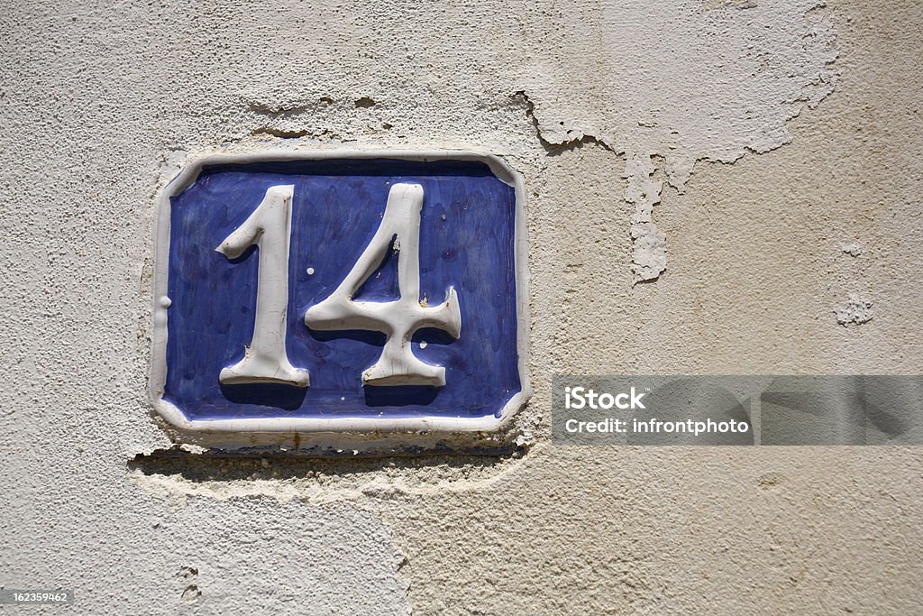 Old blue ceramic house number House number on an old wall in Italy. Architectural Feature Stock Photo