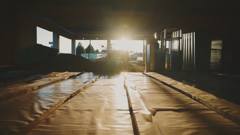 Commercial building interior under construction at sunset