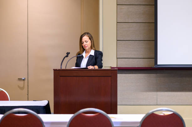 istock Businesswoman in a conference at a podium presenting or practicing a presentation 1623598310