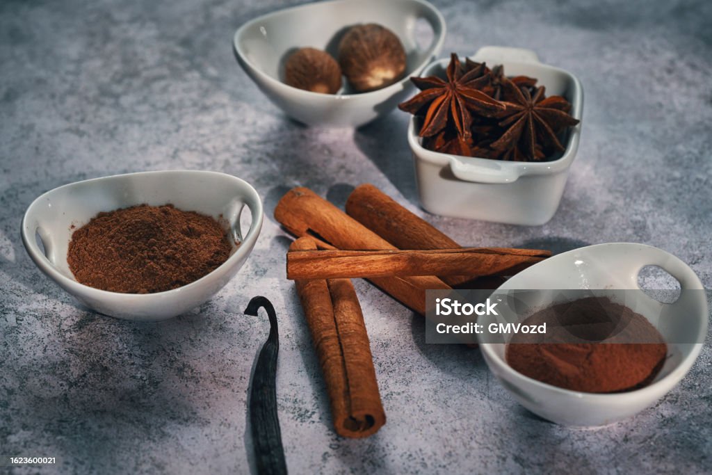 Variation of Spices Chili Powder, Cinnamon, Cayenne Pepper, Nutmeg and Star Anise Cardamom Stock Photo