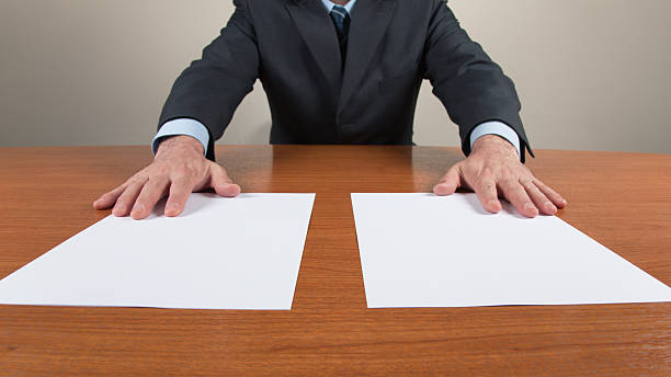 istock Businessman with Two White Sheets on the Table 162360463