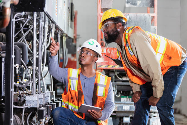 istock Two workers inspecting industrial refrigeration equipment 1623610986