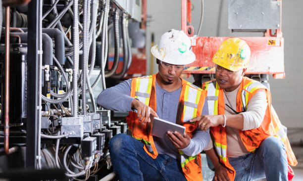 istock Two workers inspecting industrial refrigeration equipment 1623611483