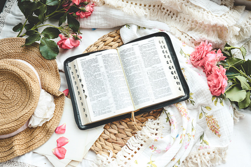 Open bible in home morning interior.