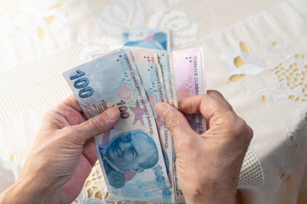 istock Hands holding Turkish Lira banknotes 1623637066