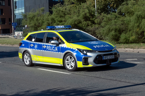 Warsaw, Poland - 15th August, 2023: Hybrid police car Suzuki Swace driving on a street. This model is a twin car for Toyota Corolla Touring Sports.