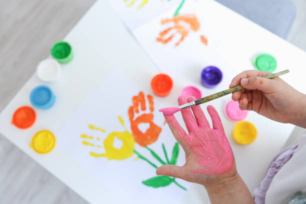 istock Children's art workshop, the child makes a handprint with paints 1623679208