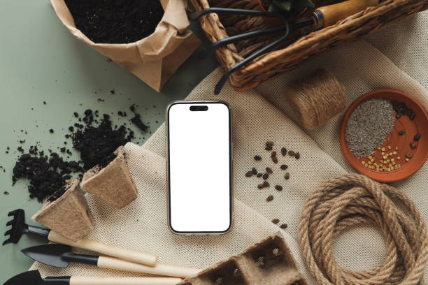 istock Phone with an isolated screen for your text on the background of garden tools 1623710117