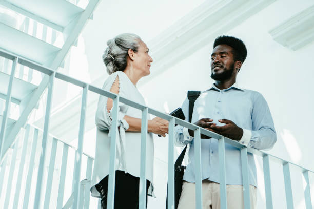 istock Coworkers or friends talking on steps 1623712289