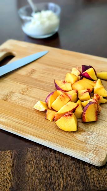 istock Fresh cut peaches on wooden cutting board 1623712320