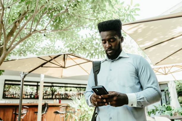 istock Young businessman walking and using mobile phone outdoors 1623712329
