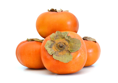 One and half Persimmons on white background.