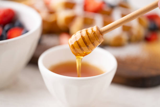 istock honey on honey stick with belgium waffle 1623717684
