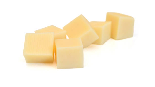 istock Cubes of cheddar cheese isolated on white 1623719766