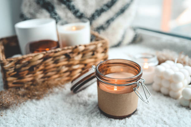 istock Burning candle in cozy home interior 1623722001