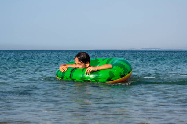 istock Boy playing with swim ring in the sea. 1623791306