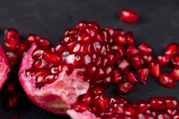 istock Grains of red ripe pomegranate close up 1623809265