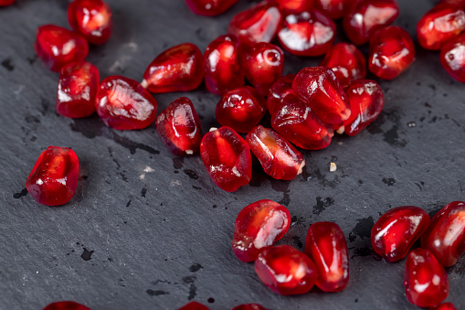 peeled red ripe pomegranate with red sweet grains, juicy pomegranate seeds of red color