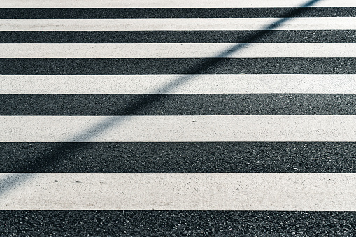 Symmetry of monochromatic parallel lines of crosswalk, asphalt rough pattern, no people