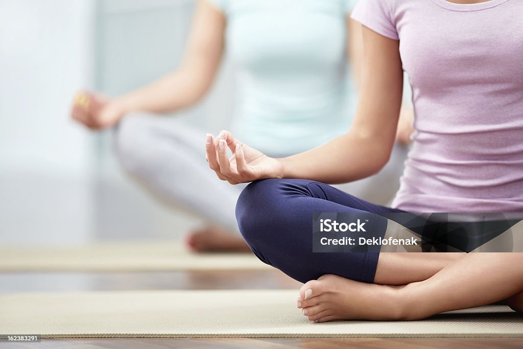 Lotus Young people do yoga indoors Activity Stock Photo
