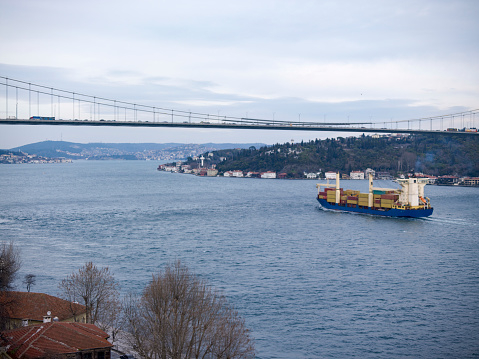 Big cargo ship in Bosphorus. A container-laden ship passing through the Bosphorus in autumn.