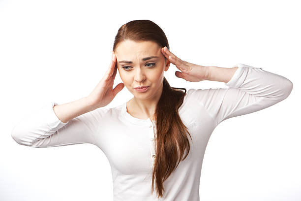 Young woman with headache on white background stock photo