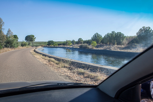 Driving beside irrigation canal. Vegas Altas del Guadiana, Badajoz, Extremadura, Spain