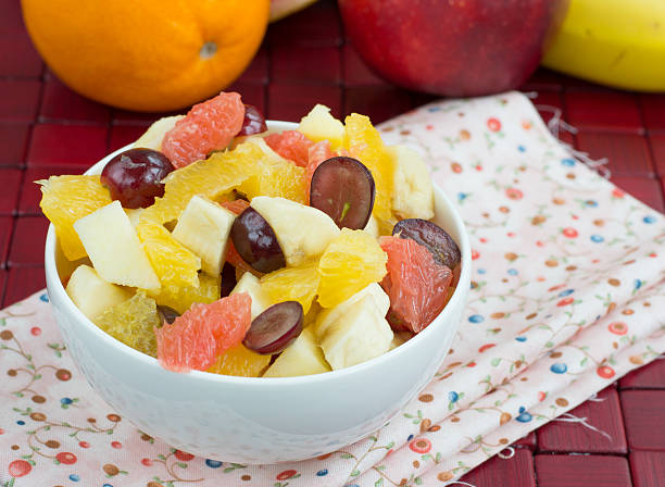 Various set fruits, pineapple, apple, grapes with matured cheddar cheese in bowls, healthy snack