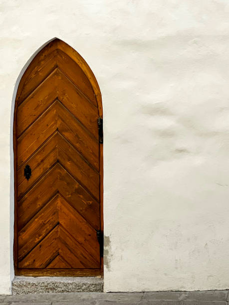 Brown Wood Door in White Wall stock photo