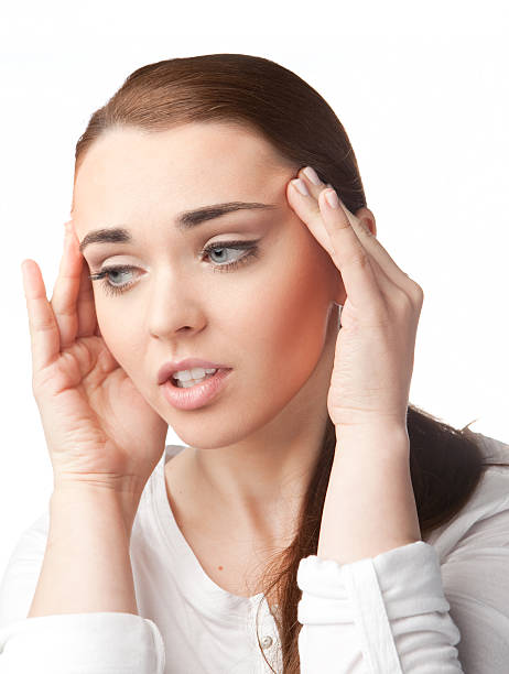 Young woman with headache on white background stock photo