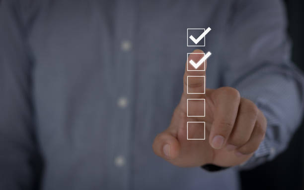 istock Checklist and clipboard task management, Assessment form, questionnaire. Businessmen touch the checked box for the productivity checklist and filling the survey form online. Document management system 1623937348