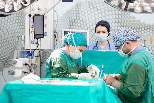 Doctor and his assistants in a modern operating room. Surgeons and doctors who save lives in the operating room.