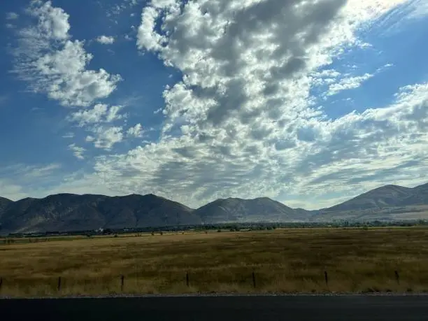 mbark on a whimsical journey through the sky as fluffy clouds paint the canvas of a road trip, where every contour whispers tales of adventure and dreams.