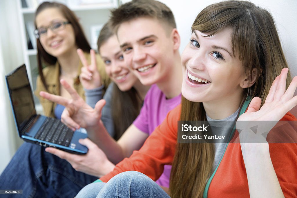 teens - friends Close-up of four teenagers laughing and gesturing at camera Adult Stock Photo