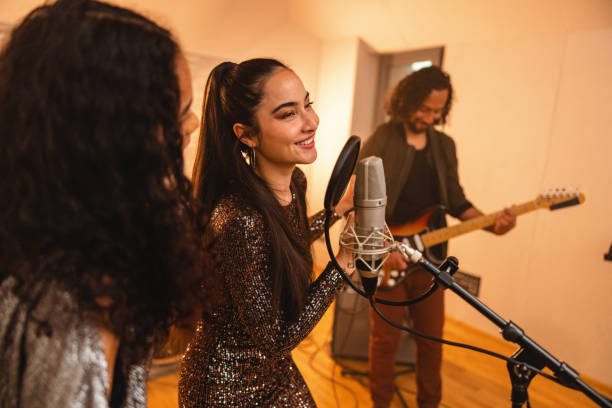 istock Smiling Band Mates Singing In A Recording Studio 1624019722
