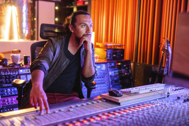 istock Black Male Audio Engineer Working On A Digital Music Mixer Console In A Recording Studio 1624019745